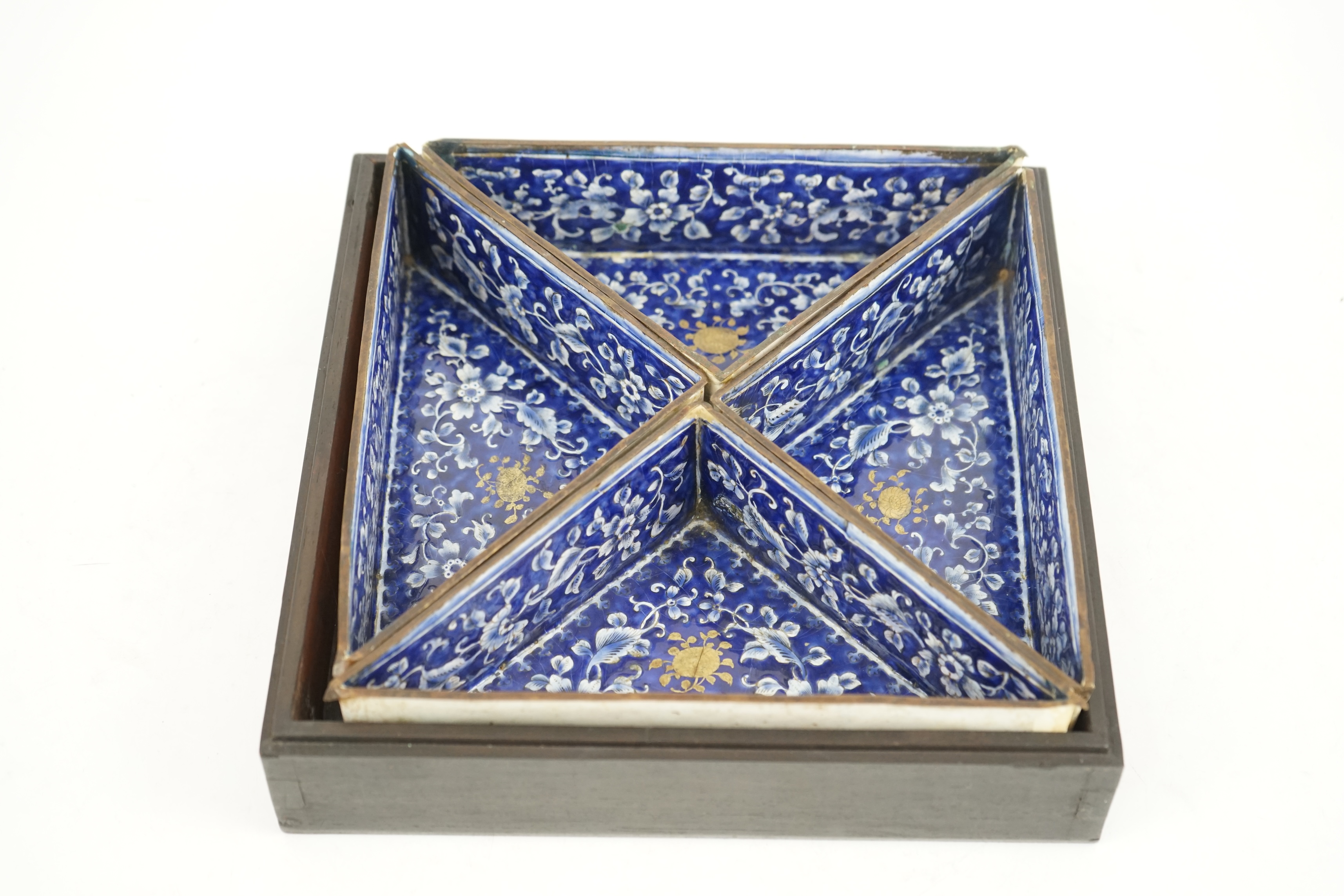 Four triangular 19th century Chinese Canton enamel sectional dishes, later boxed, 24cm wide overall. Condition - some restoration